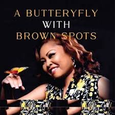 A BUTTERFLY WITH BROWN SPOTS